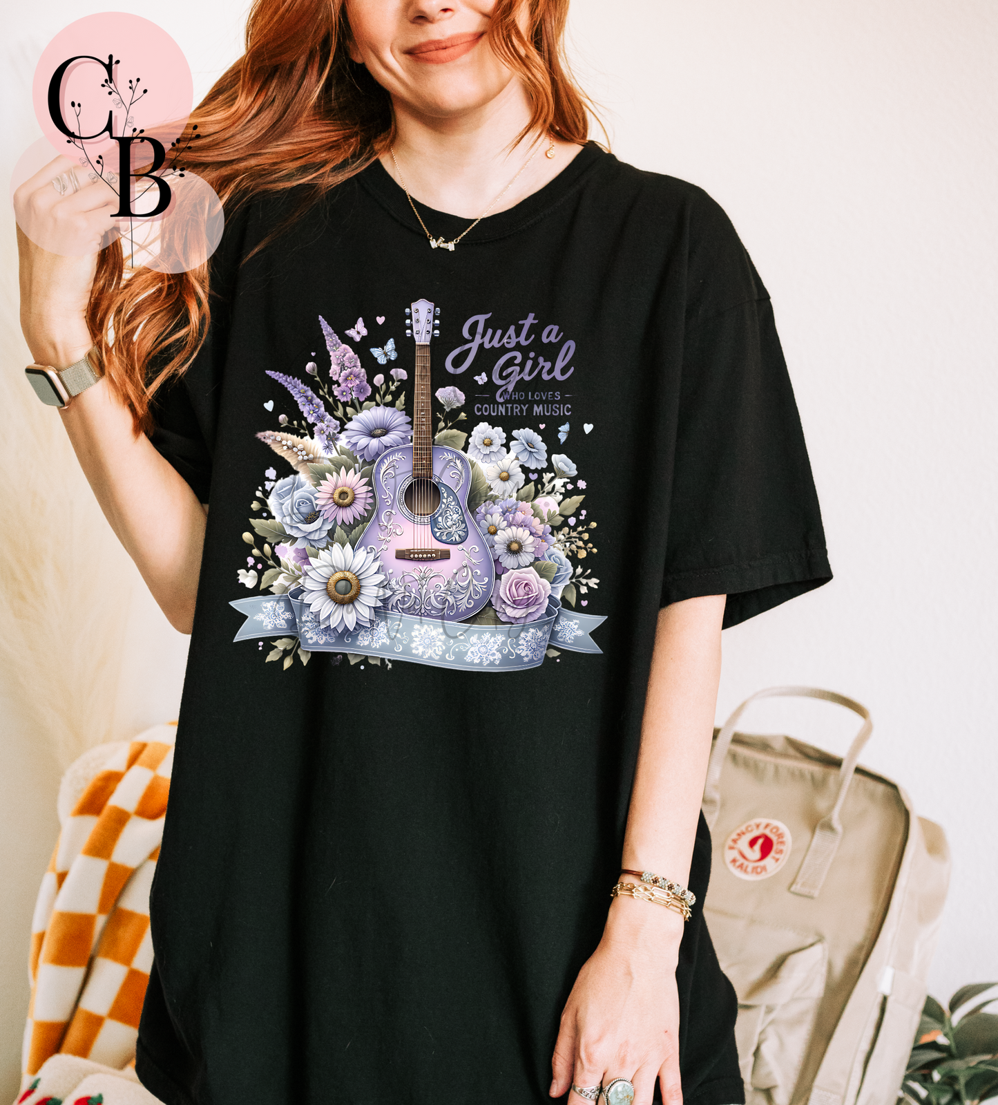 Purple "Just A Girl Who Loves Country Music" t-shirt by Creative Butterfly, featuring white text design on fabric.