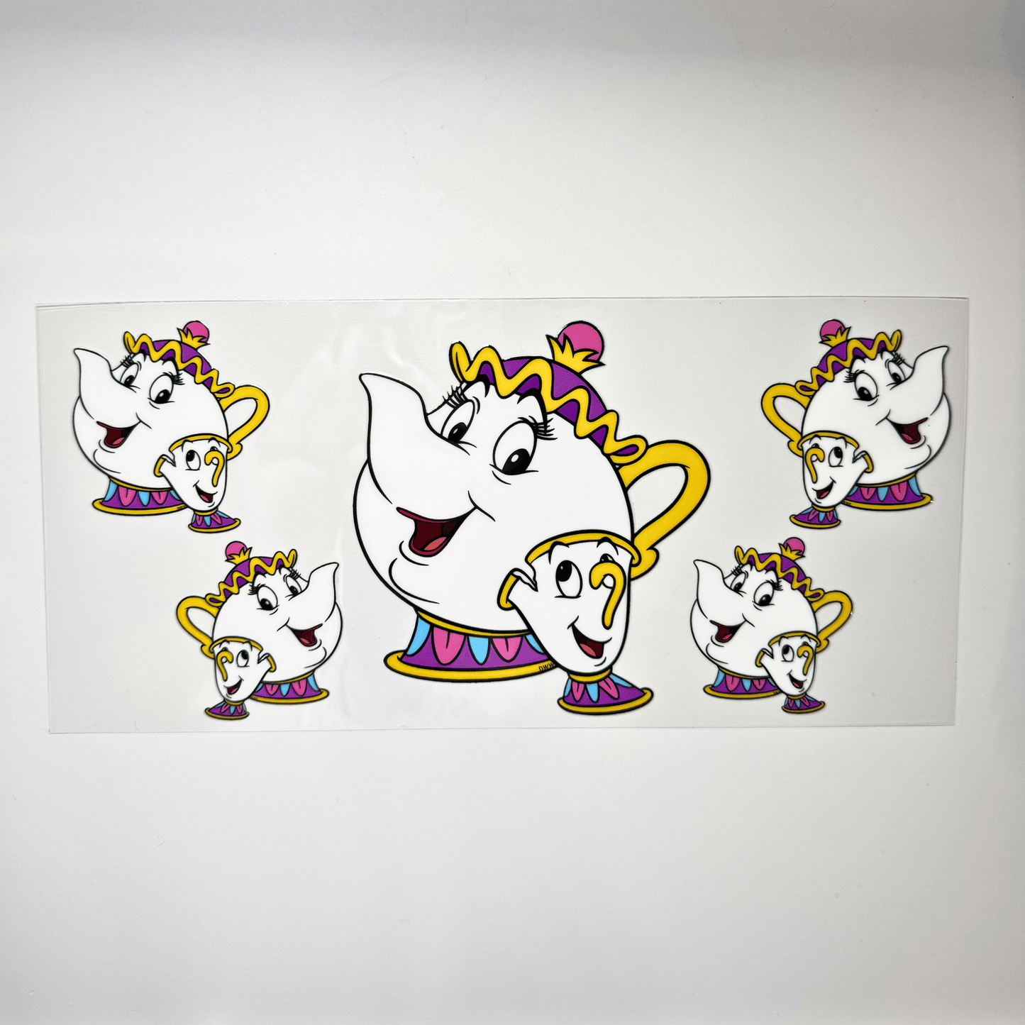 Creative Butterfly Mrs. Pots & Chip ceramic figurines, colorful decorative kitchen accessories on a white background.