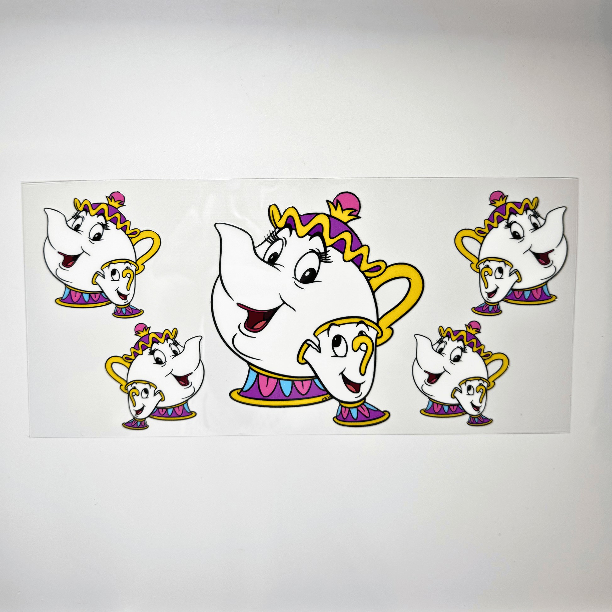 Creative Butterfly Mrs. Pots & Chip ceramic figurines, colorful decorative kitchen accessories on a white background.